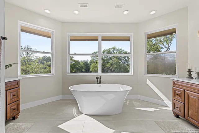 a white bath tub sitting in a room next to a window