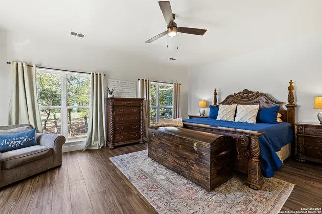 a bedroom with a bed a couch and dresser