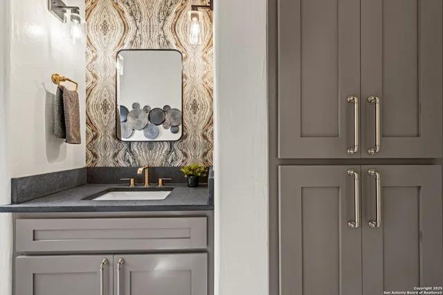 a bathroom with a sink and a mirror