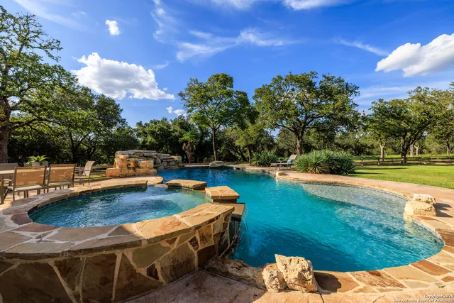 a view of a swimming pool with a yard