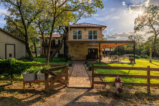 a view of a house with backyard sitting area and garden