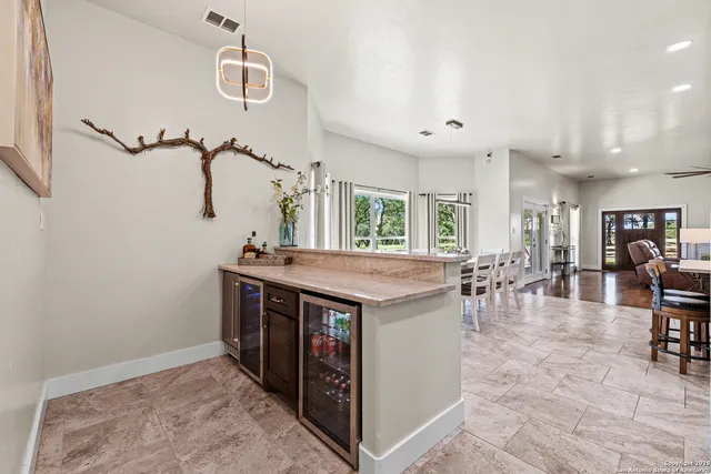 a view of kitchen island with stainless steel appliances cabinets