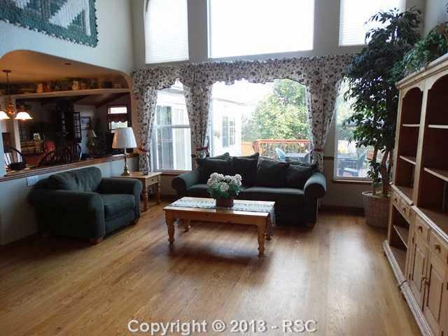 9065 Rutledge Drive Colorado Springs, CO 80920 - Photo 4 of 25 Formal living room with a wall of windows.