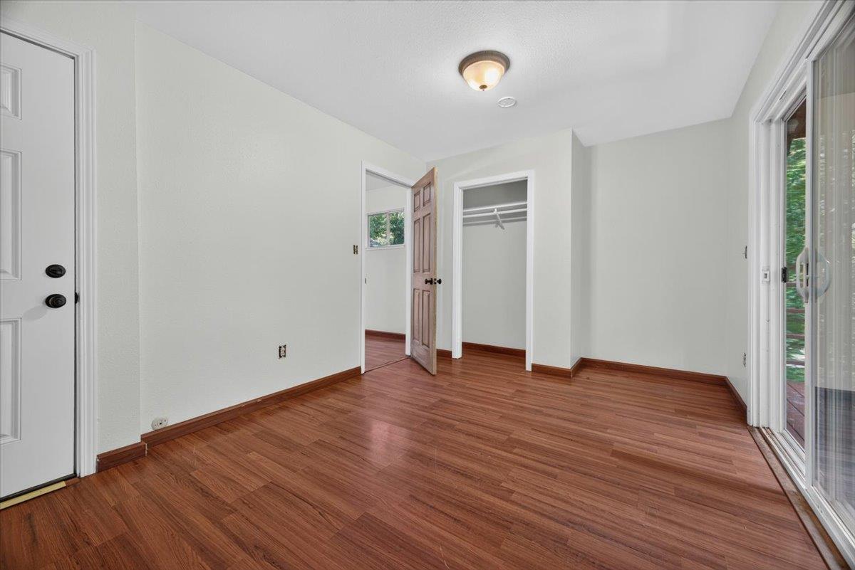 514 Primavera Road Boulder Creek, CA 95006 - Photo 32 of 40 an empty room with wooden floor and windows