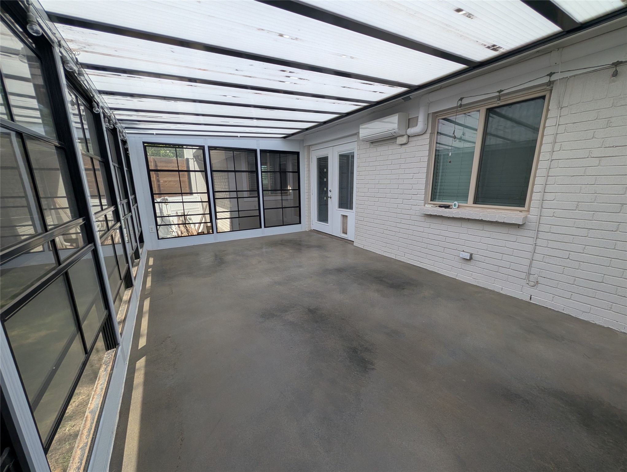 4601 Tamarack Trail Austin, TX 78727 - Photo 6 of 19 A spacious sunroom offers abundant natural light and seamless indoor-outdoor living.