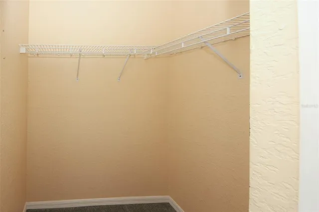 an empty room with fan and entrance