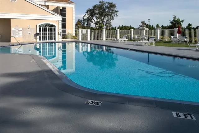 a view of tennis court with trees in the background