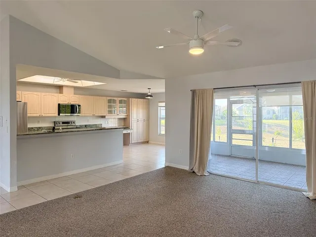 a view of a kitchen with large windows