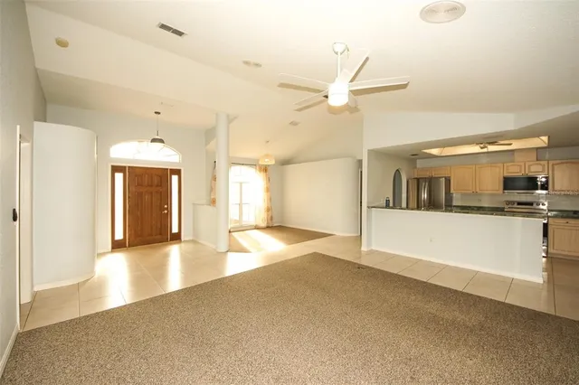 a view of a kitchen with a sink and a window