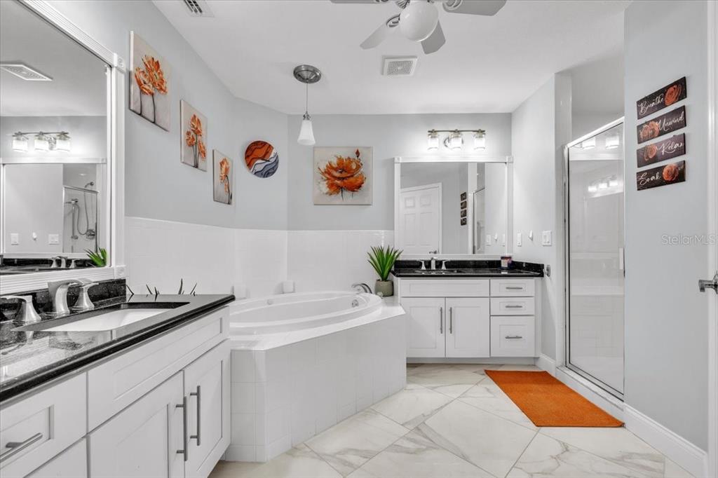 1260 Rio De Janeiro Avenue, Unit 102 Punta Gorda, FL 33983 - Photo 25 of 46 a spacious bathroom with a sink double vanity and a mirror