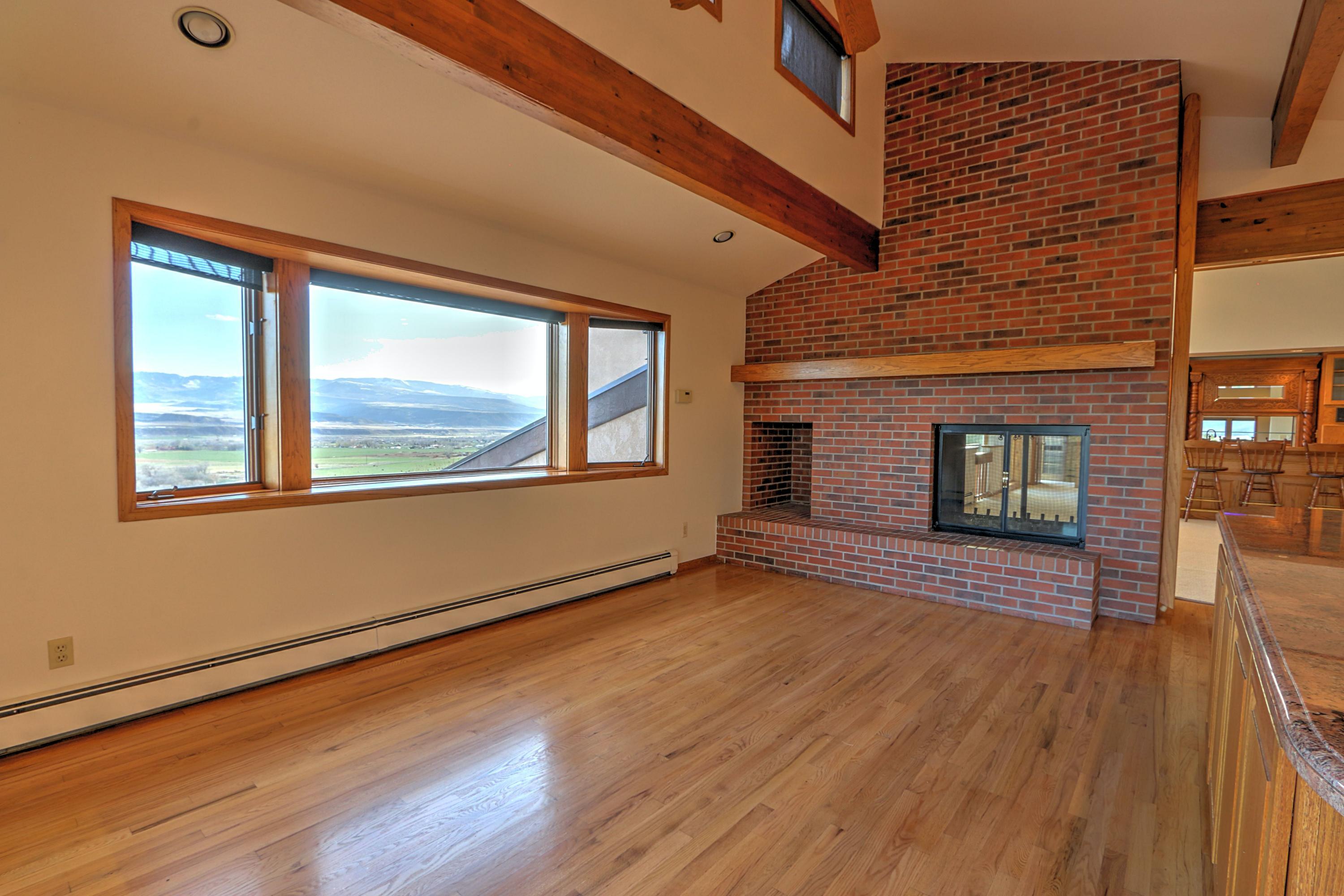 534 Panoramic Drive Silt, CO 81652 - Photo 12 of 48 a view of an empty room with wooden floor and a window