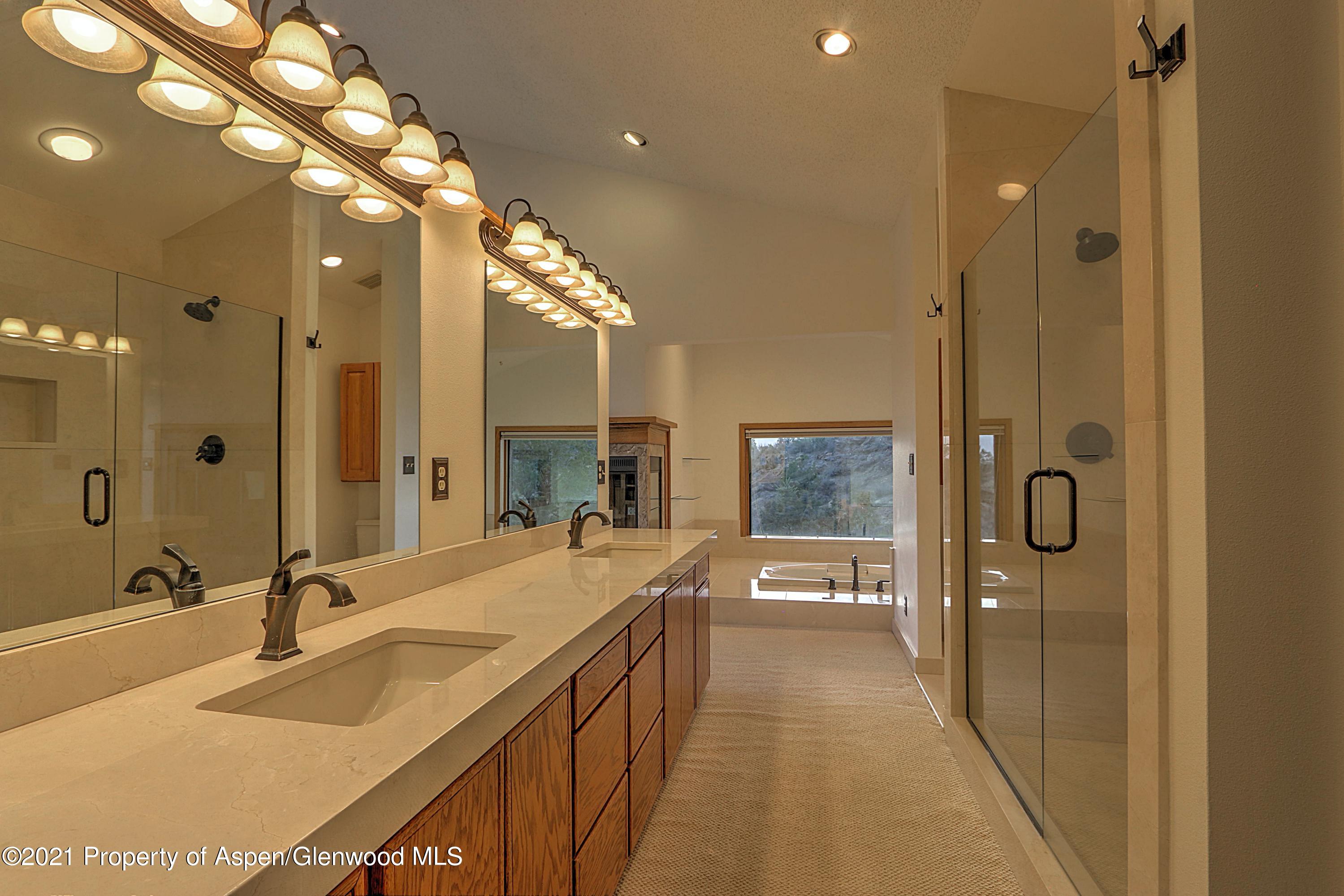 534 Panoramic Drive Silt, CO 81652 - Photo 22 of 48 a spacious bathroom with a sink a shower and a mirror