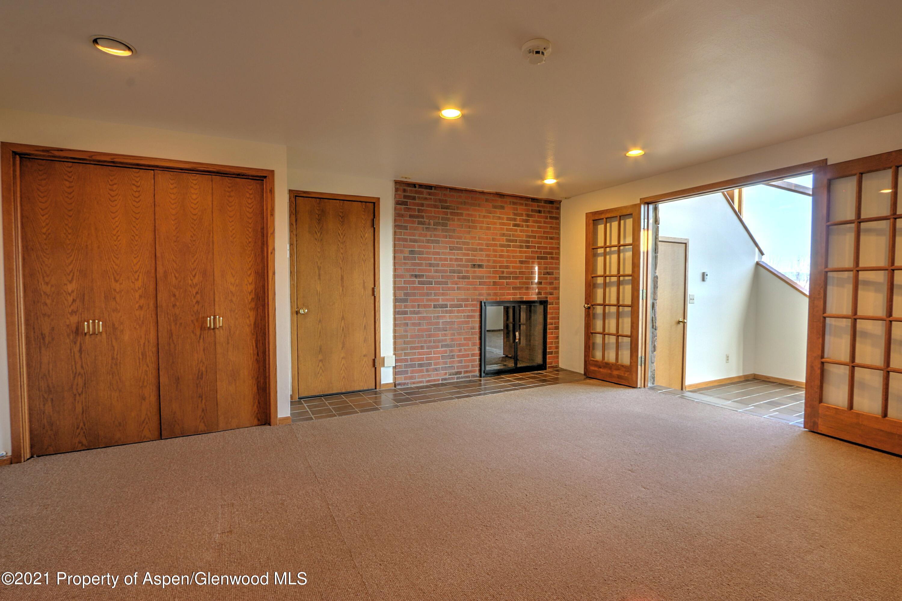 534 Panoramic Drive Silt, CO 81652 - Photo 23 of 48 an empty room with fireplace and a window