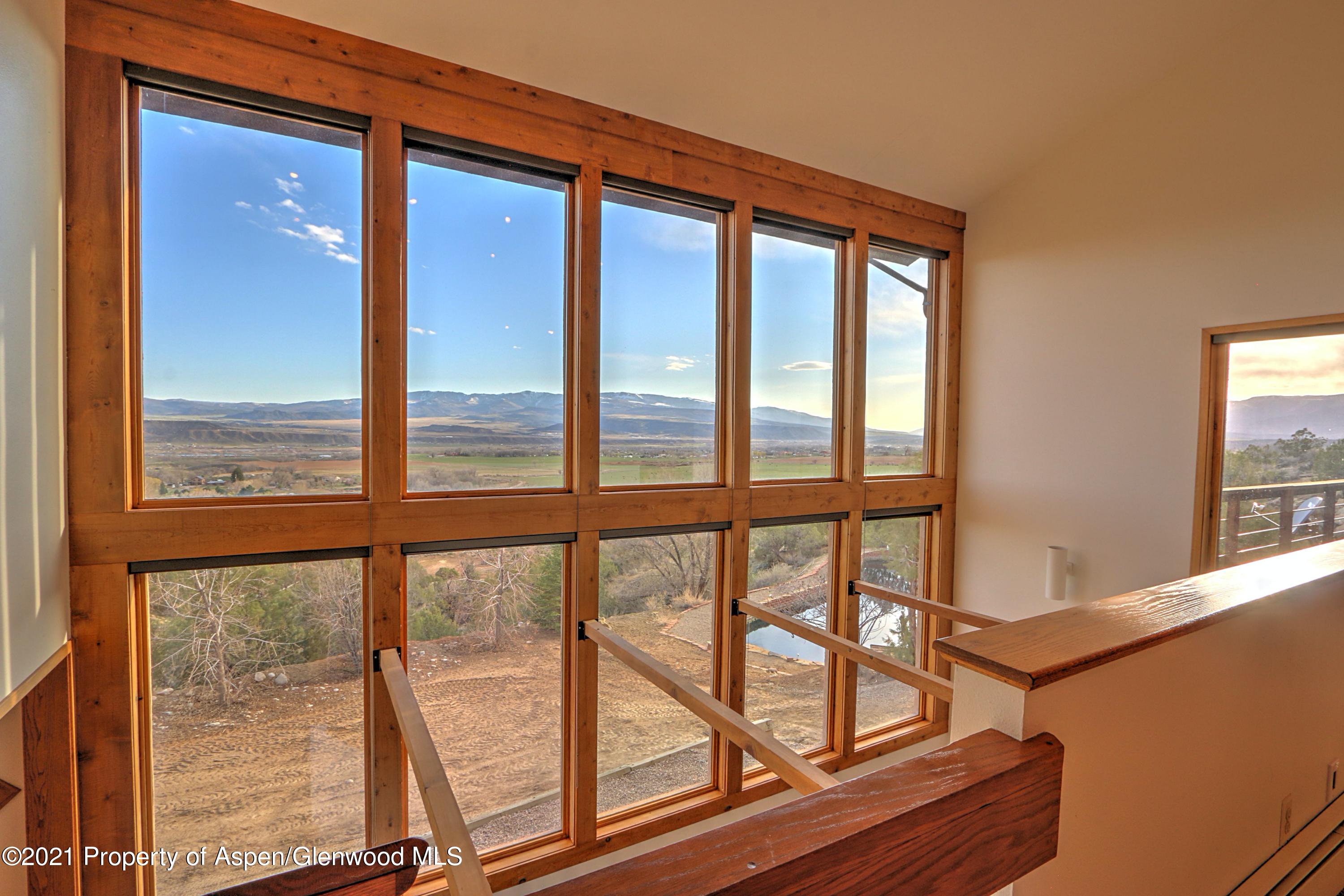 534 Panoramic Drive Silt, CO 81652 - Photo 26 of 48 a view of an empty room with wooden floor and a window