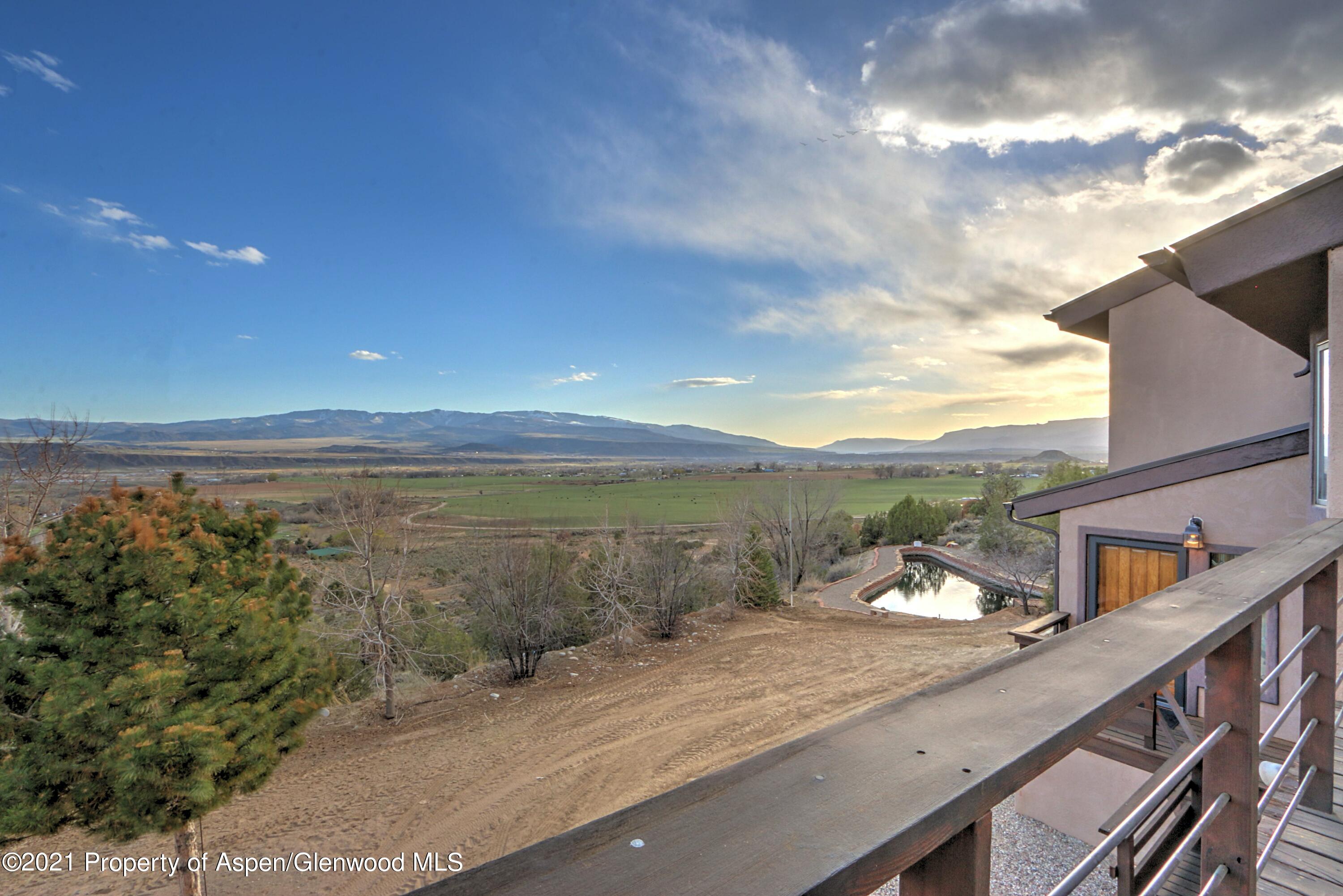 534 Panoramic Drive Silt, CO 81652 - Photo 40 of 48 a view of a lake with a table and chairs next to a yard