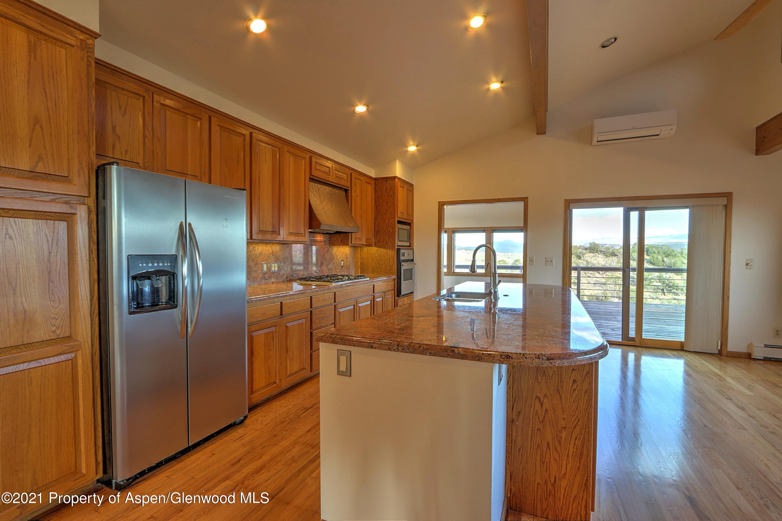 534 Panoramic Drive Silt, CO 81652 - Photo 10 of 48 a kitchen with stainless steel appliances granite countertop a refrigerator a sink and a stove