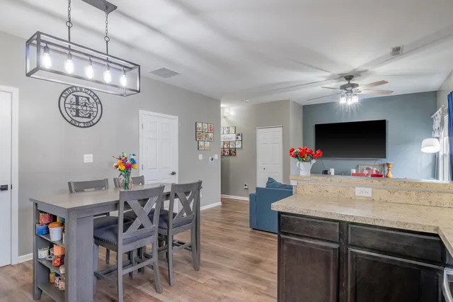 a view of a dining room with furniture and a chandelier