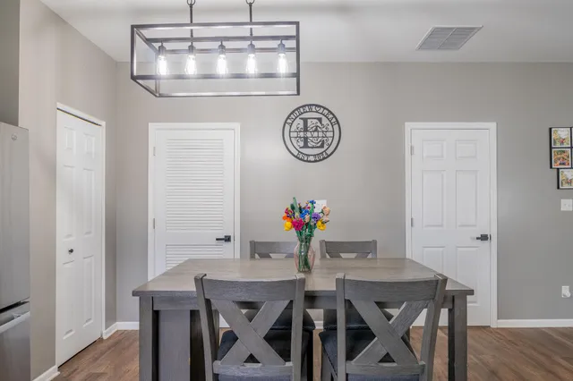 a view of a dining room with furniture and wooden floor