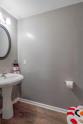 a bathroom with a toilet mirror and vanity