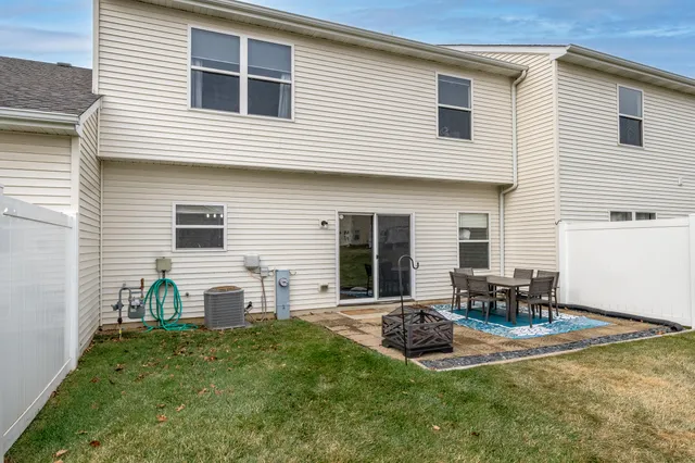 a view of a house with backyard and sitting area