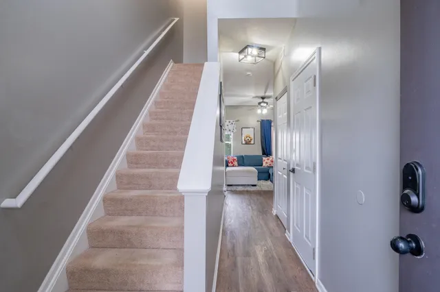 a view of entryway and hall with wooden floor
