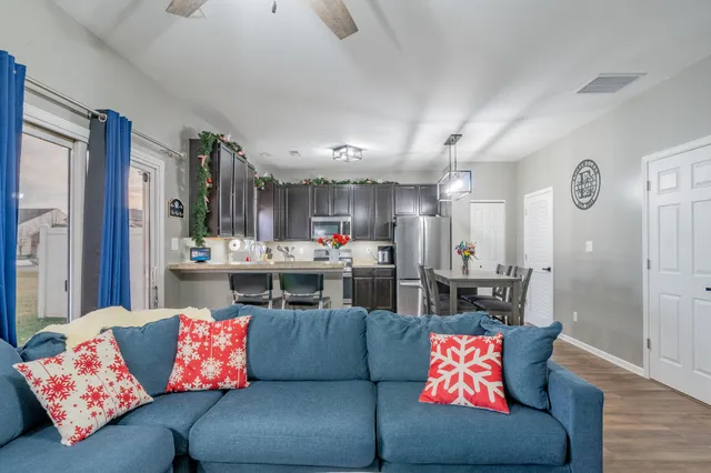 a living room with furniture and kitchen view