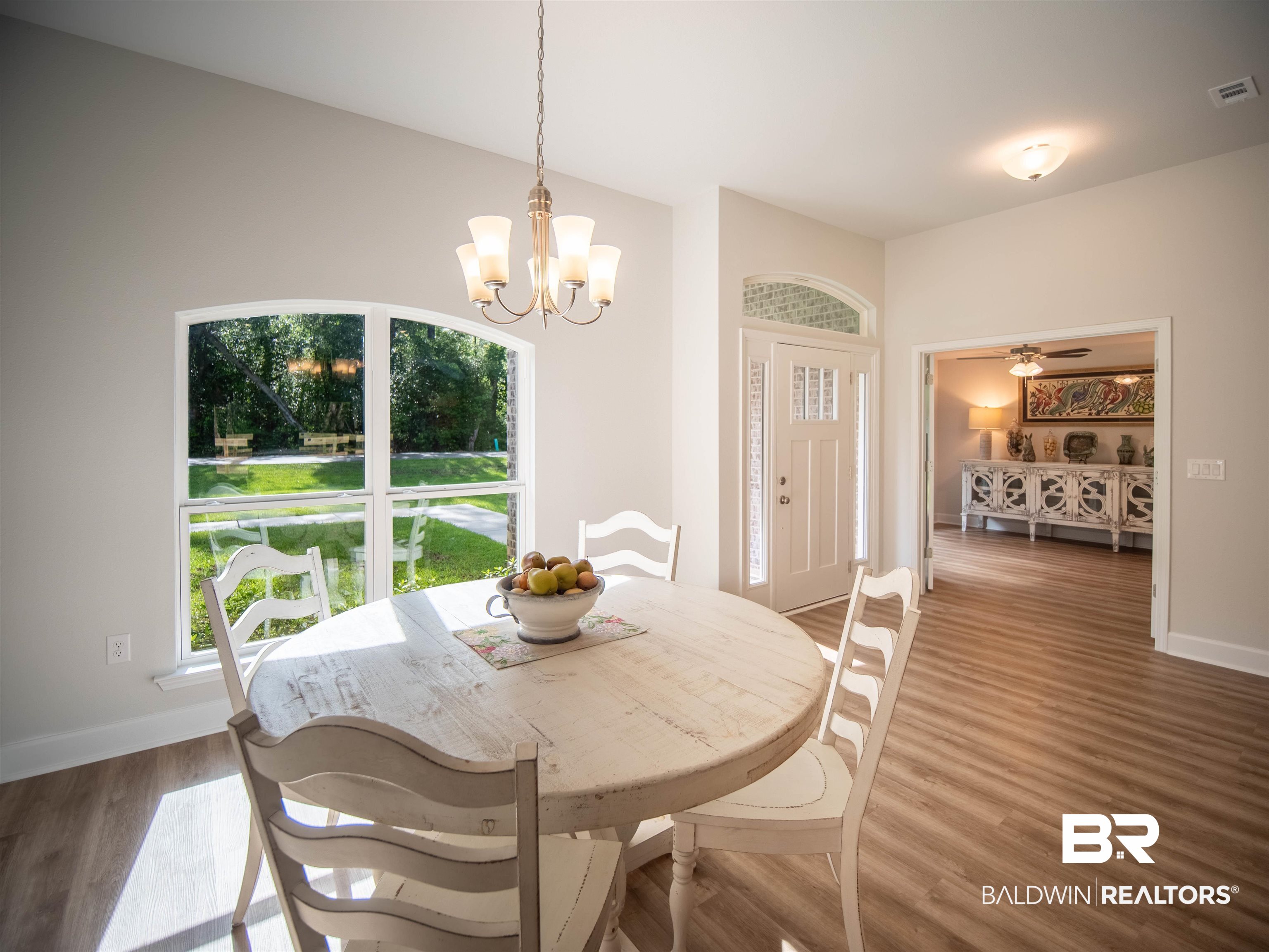 12646 Michigan Avenue Elberta, AL 36530 - Photo 5 of 47 Dining room featuring plenty of natural light, a chandelier, and wood finished floors