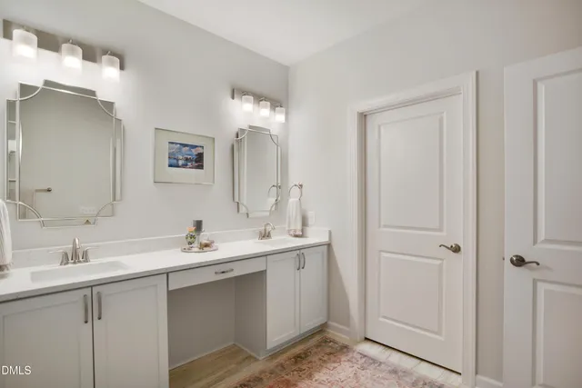 a bathroom with a sink double vanity and a mirror