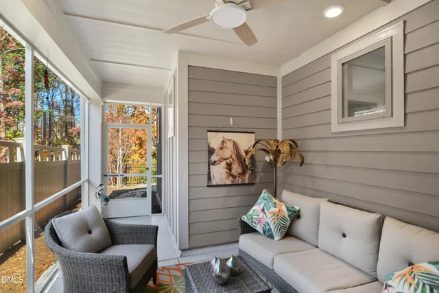 a living room with furniture and a floor to ceiling window
