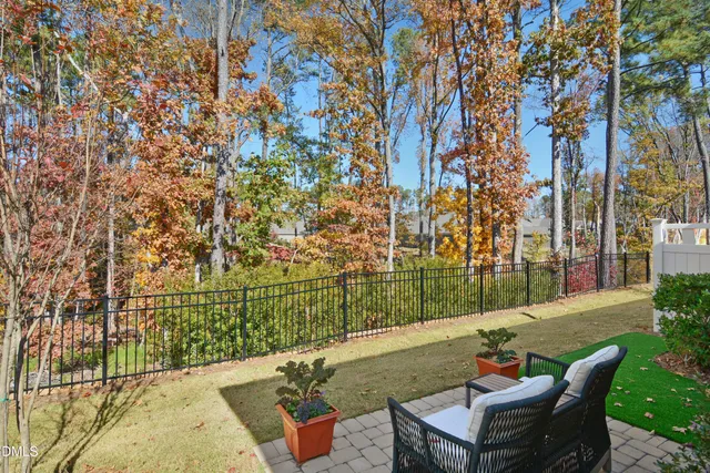 a view of a patio with iron fence