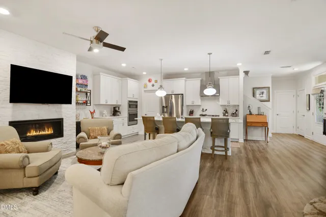 a living room with furniture a fireplace and a flat screen tv