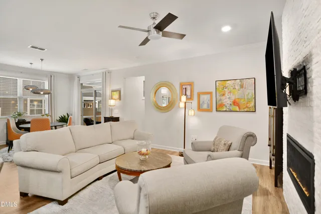 a living room with furniture a rug and a flat screen tv