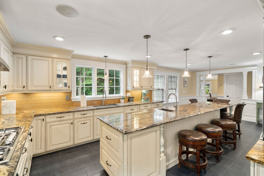 14 Sunset Road Wellesley, MA 02482 - Photo 11 of 39 a large kitchen with kitchen island a large counter space a sink stainless steel appliances and cabinets