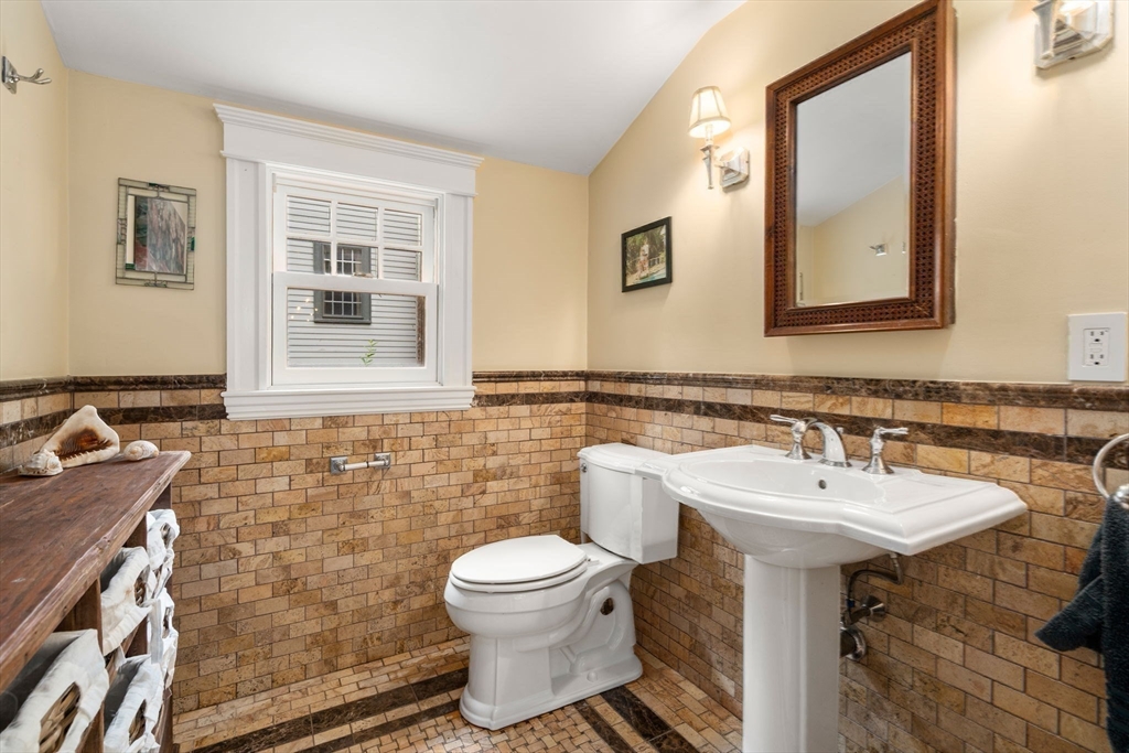 14 Sunset Road Wellesley, MA 02482 - Photo 16 of 39 a bathroom with a toilet sink and mirror
