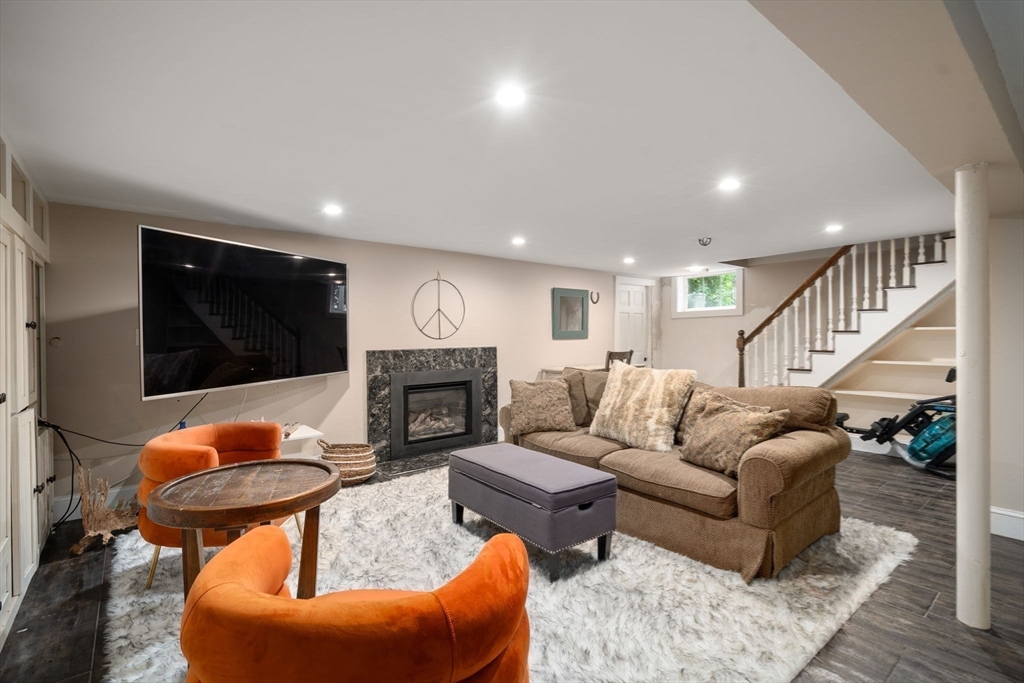 14 Sunset Road Wellesley, MA 02482 - Photo 25 of 39 a living room with furniture a flat screen tv and a fireplace