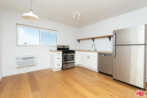 a kitchen with stainless steel appliances a refrigerator and a stove