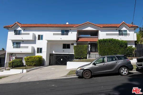 a view of a car parked in front of a house