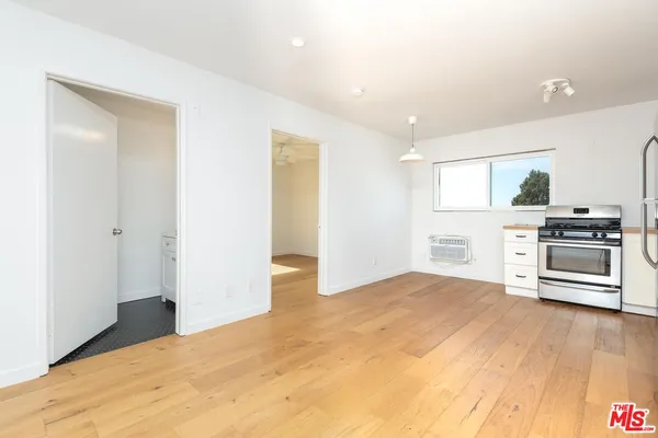 a kitchen with stainless steel appliances a refrigerator and a stove top oven