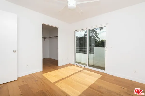 a view of a room with wooden floor