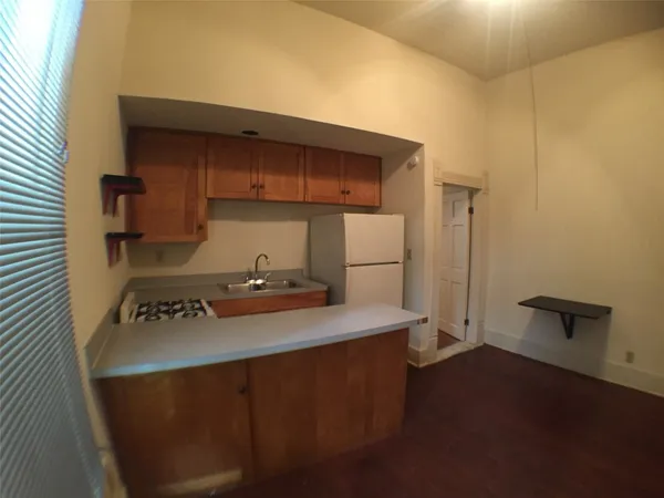a kitchen with a sink a stove and a refrigerator