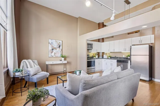 a living room with furniture and a kitchen view
