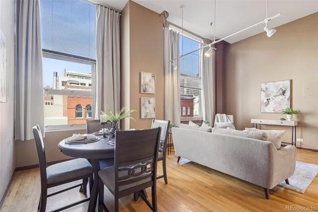 a dining room with furniture and wooden floor