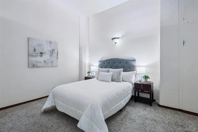 a bedroom with a bed and a night stand