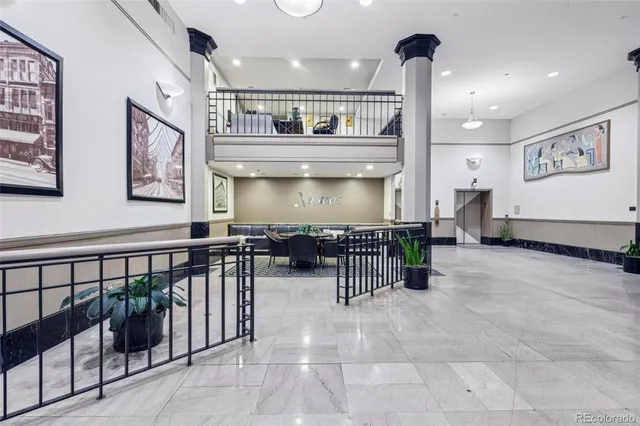 a view of a dining room with furniture and a chandelier