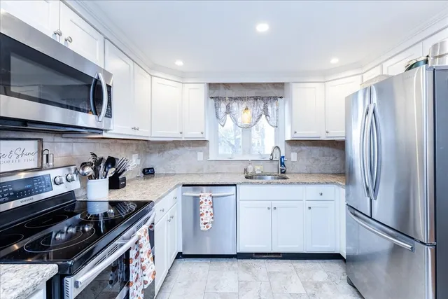 a kitchen with a sink stove and microwave