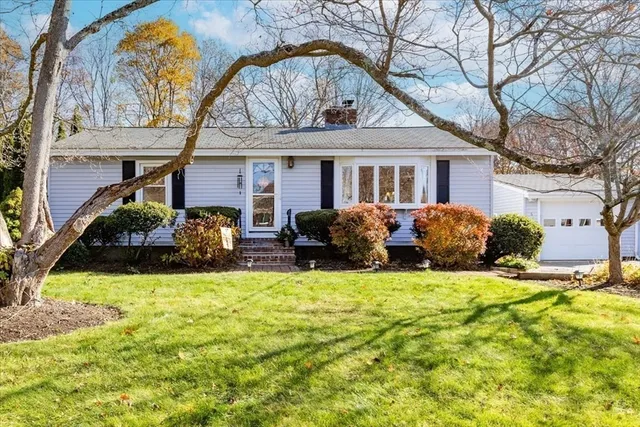 a view of a house with backyard and sitting area