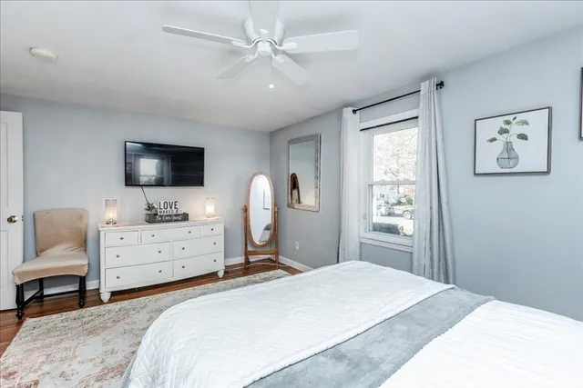 a bedroom with a large bed and a flat screen tv