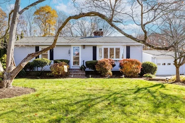a view of a house with backyard and sitting area