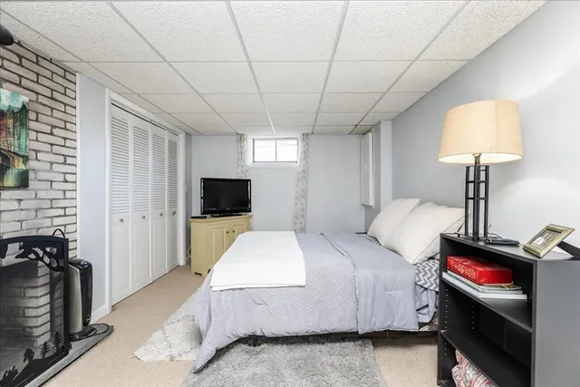 a spacious bedroom with a bed and a flat screen tv