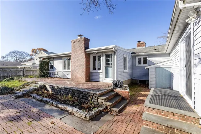 a view of a house with backyard and sitting area